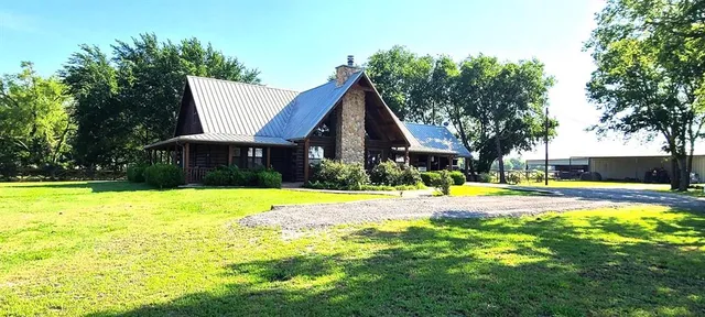 a view of a swimming pool with plants and small yard