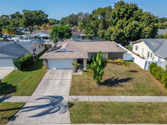 an aerial view of a house with garden space and sitting area