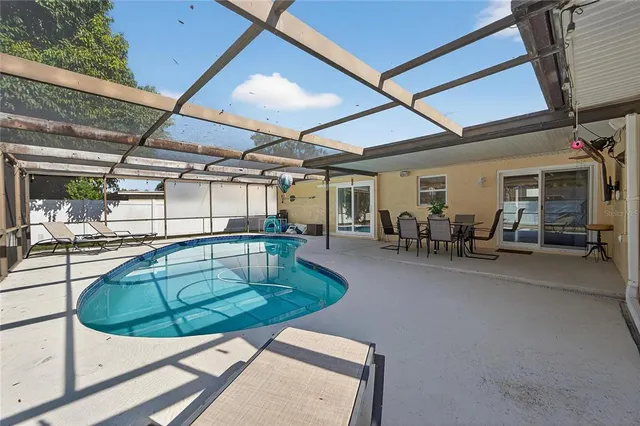 a view of a swimming pool with outdoor seating