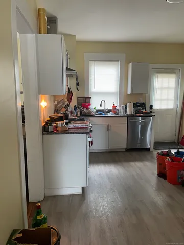 a kitchen with stainless steel appliances granite countertop a refrigerator and a stove