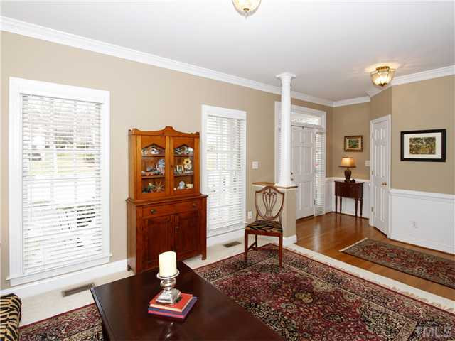 2021 Carrbridge Way Raleigh, NC 27615 - Photo 5 of 25 ANOTHER VIEW OF THE LIVING ROOM AS IT OPENS TO THE FOYER. NOTICE THE LARGE WINDOWS THAT ALLOW LOTS OF LIGHT INTO THE ROOM AND THE COLUMN FEATURE THAT DEFINES THE FOYER. THAT'S A COAT CLOSET TO THE RIGHT OF THE FRONT ENTRANCE. Living Room
