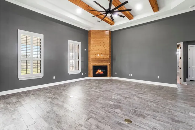 a living room with furniture a large window and a flat screen tv