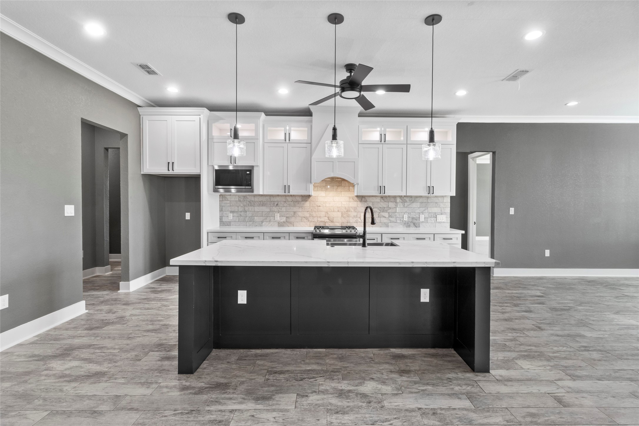 22010 Chenango Lake Drive Angleton, TX 77515 - Photo 8 of 43 a large kitchen with kitchen island a sink stainless steel appliances and cabinets