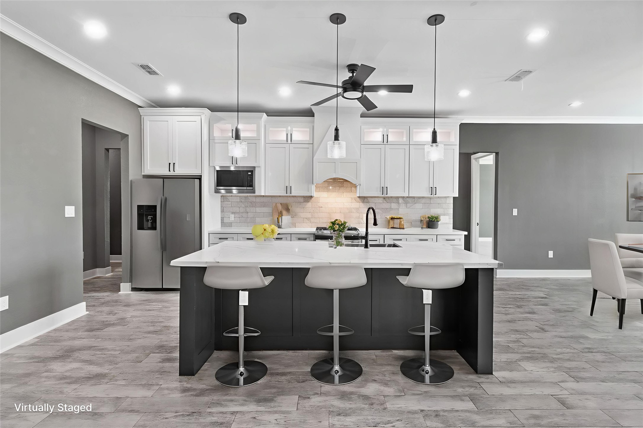 22010 Chenango Lake Drive Angleton, TX 77515 - Photo 9 of 43 a kitchen with a dining table chairs sink and wooden floor