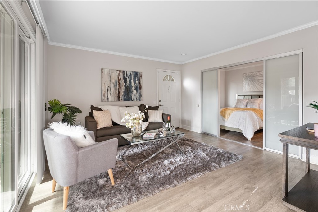 3128 Via Alicante, Unit R La Jolla, CA 92037 - Photo 1 of 1 a living room with furniture and a lamp