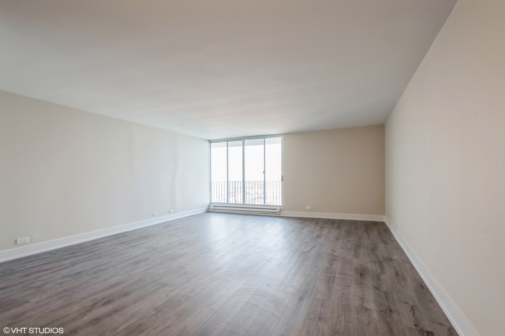 6033 North Sheridan Road, Unit 44D Chicago, IL 60660 - Photo 11 of 12 a view of an empty room with wooden floor and window