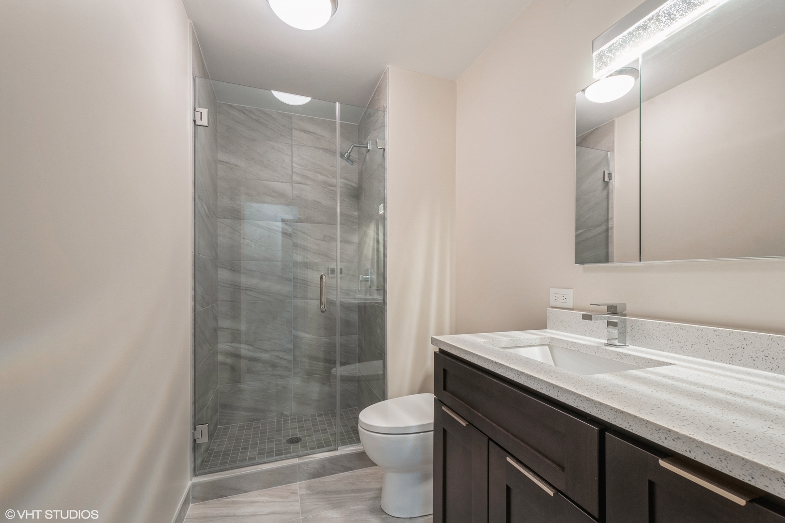 6033 North Sheridan Road, Unit 44D Chicago, IL 60660 - Photo 12 of 12 a bathroom with a granite countertop sink toilet and shower