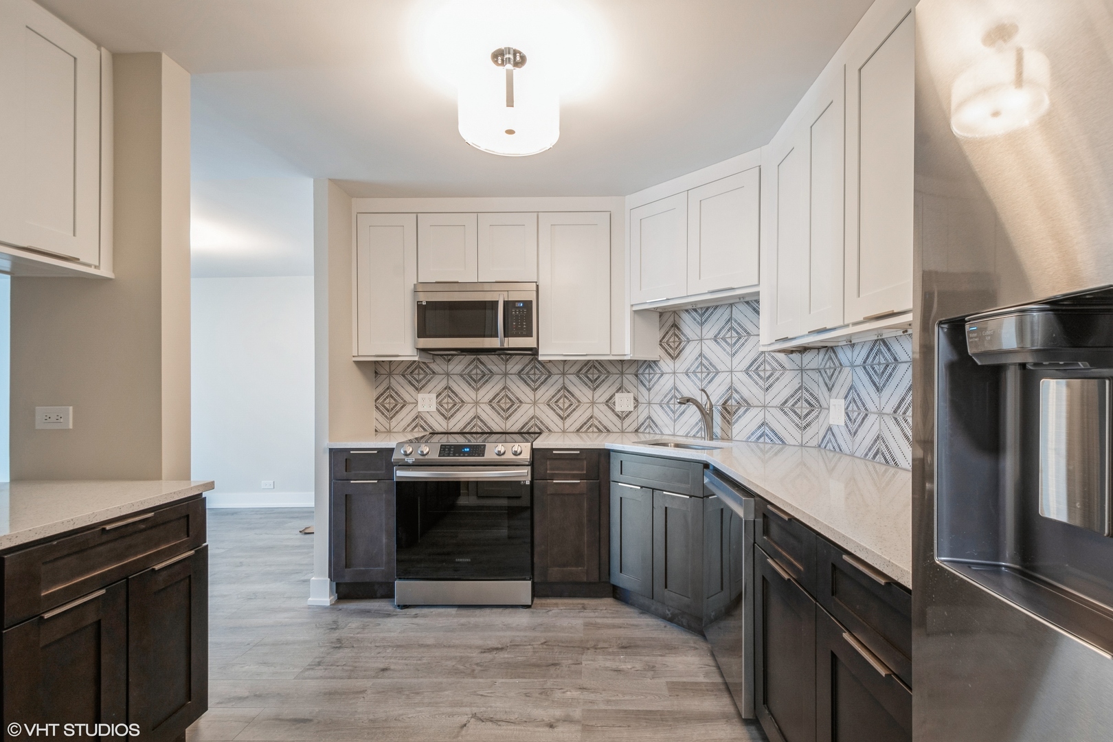 6033 North Sheridan Road, Unit 44D Chicago, IL 60660 - Photo 6 of 12 a kitchen with stainless steel appliances granite countertop a stove sink and cabinets