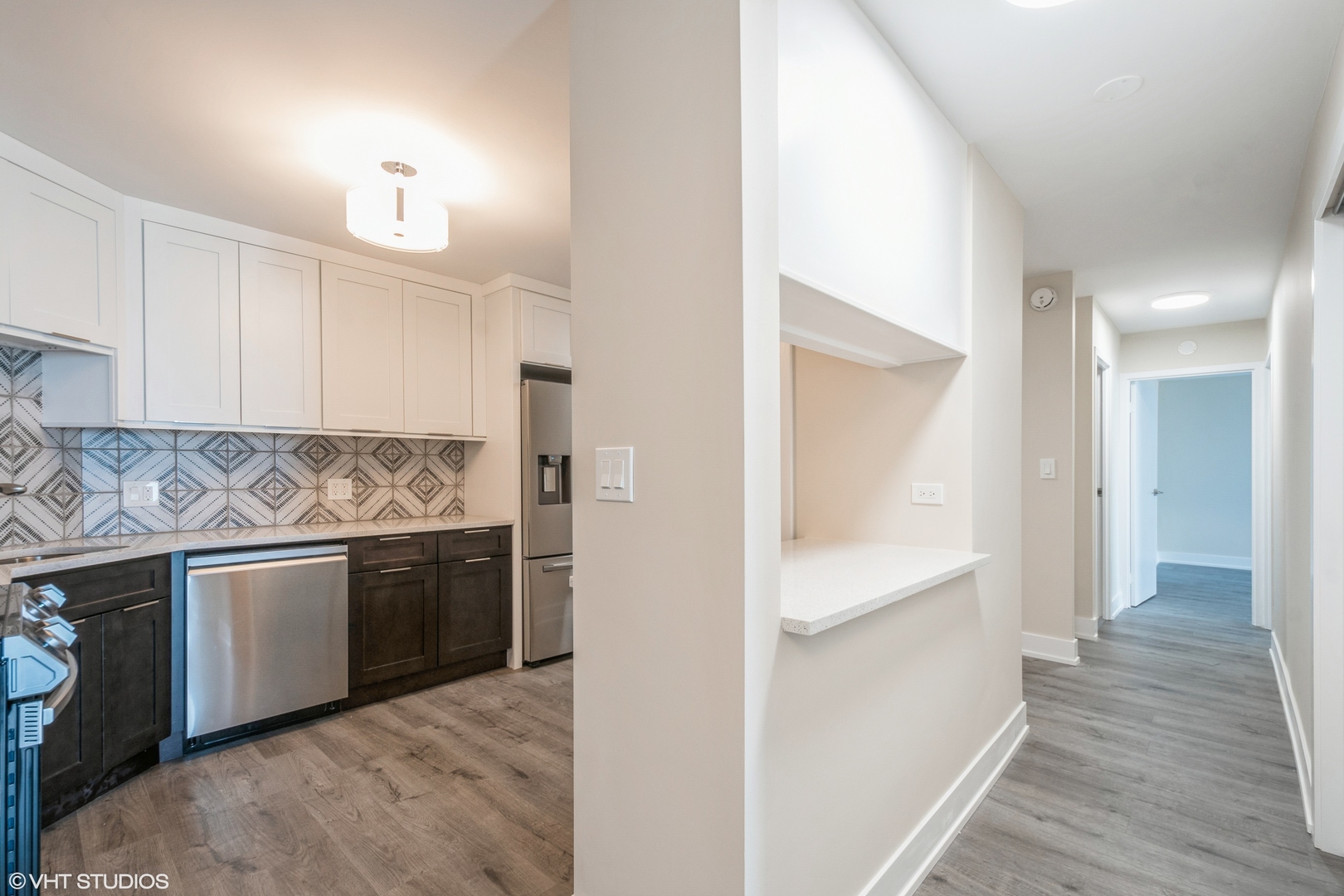 6033 North Sheridan Road, Unit 44D Chicago, IL 60660 - Photo 7 of 12 a kitchen with stainless steel appliances granite countertop a refrigerator and a sink