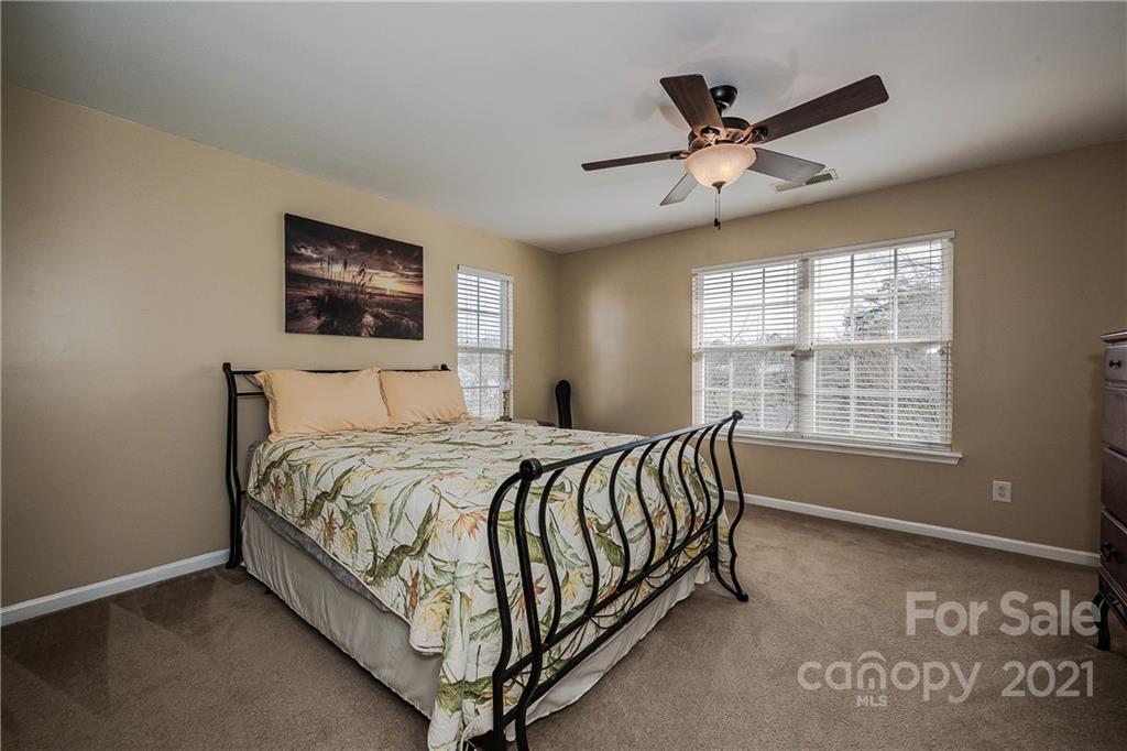 11661 Coddington Ridge Drive Charlotte, NC 28214 - Photo 15 of 23 a bed sitting in a spacious bedroom next to a window