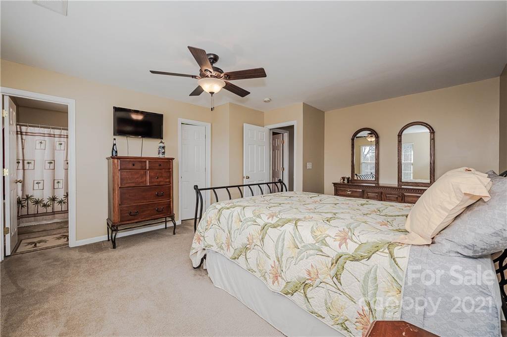 11661 Coddington Ridge Drive Charlotte, NC 28214 - Photo 16 of 23 a bed room with a bed and a television