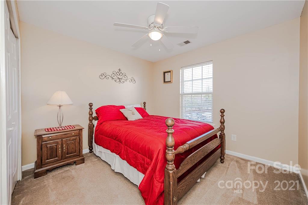 11661 Coddington Ridge Drive Charlotte, NC 28214 - Photo 18 of 23 a bed room with a bed and a chandelier