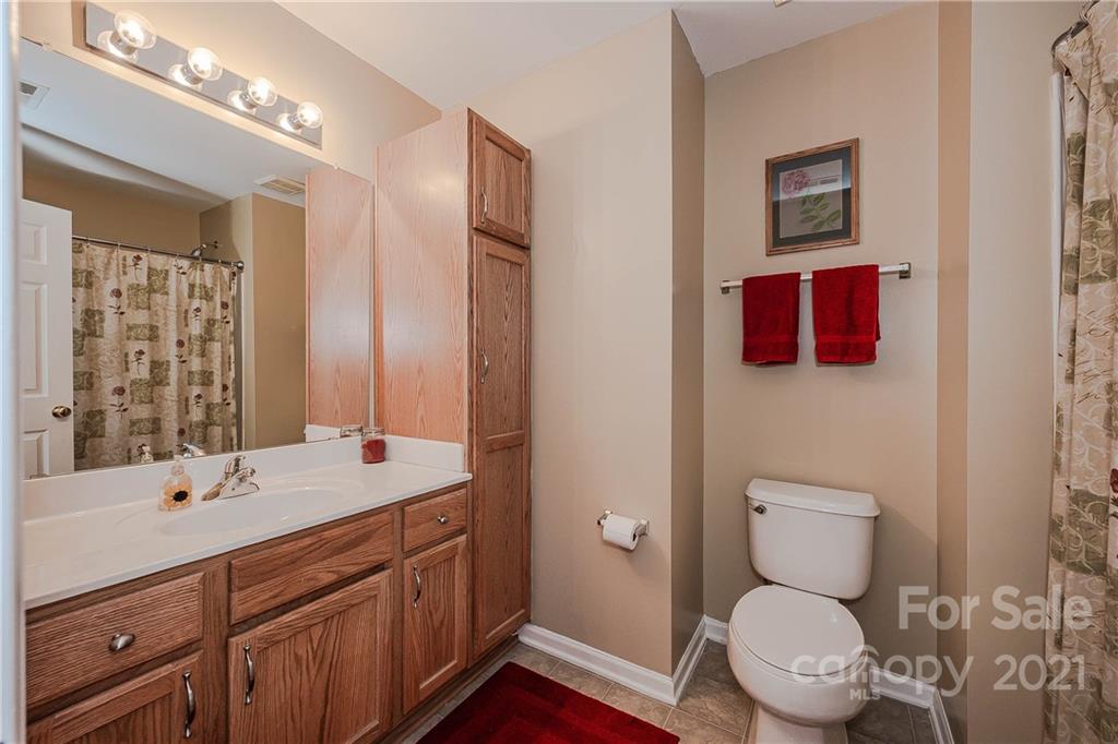 11661 Coddington Ridge Drive Charlotte, NC 28214 - Photo 19 of 23 a bathroom with a toilet sink double vanity and mirror