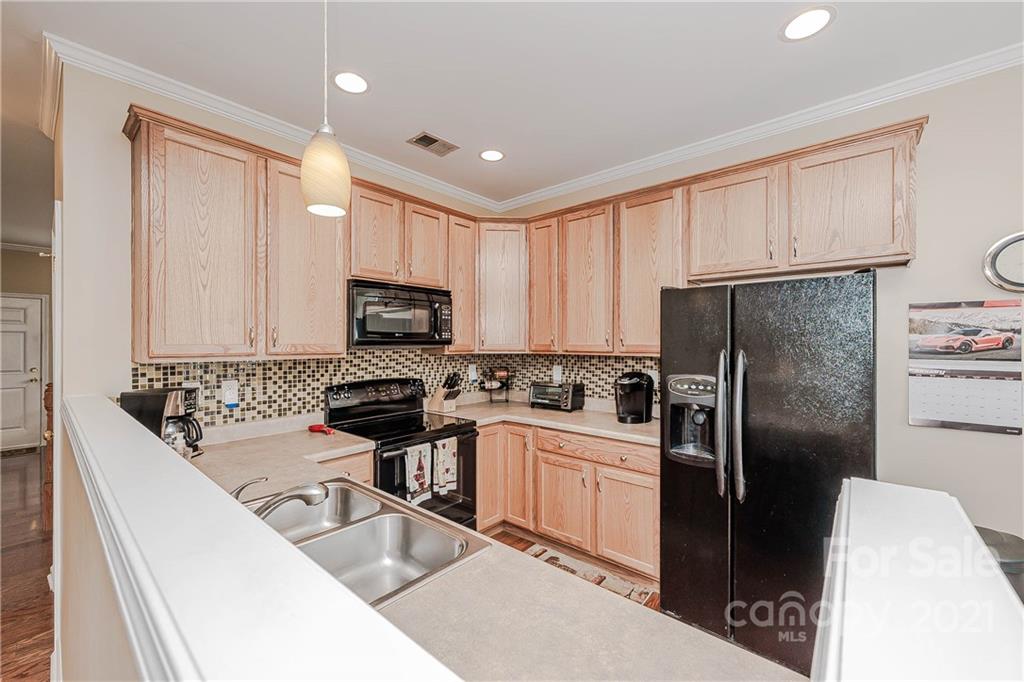 11661 Coddington Ridge Drive Charlotte, NC 28214 - Photo 3 of 23 a kitchen with stainless steel appliances granite countertop a refrigerator sink stove microwave and cabinets