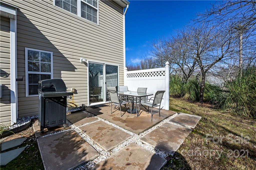 11661 Coddington Ridge Drive Charlotte, NC 28214 - Photo 21 of 23 a view of a patio with table and chairs with wooden floor and fence