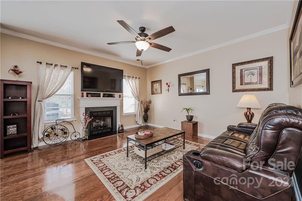 11661 Coddington Ridge Drive Charlotte, NC 28214 - Photo 7 of 23 a living room with furniture a fireplace and a flat screen tv