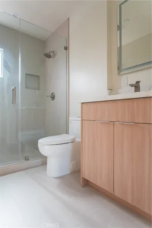 a white toilet sitting next to a bathroom sink