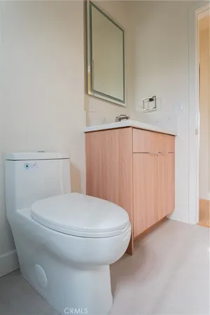 a bathroom with a toilet and a mirror