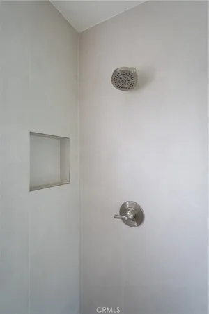 a wall with a shower and a stove