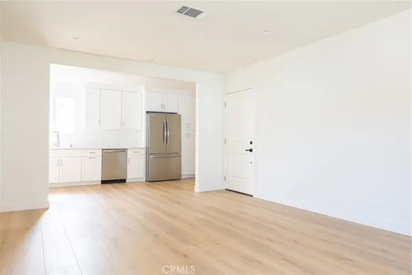 a view of a kitchen with a sink and a refrigerator