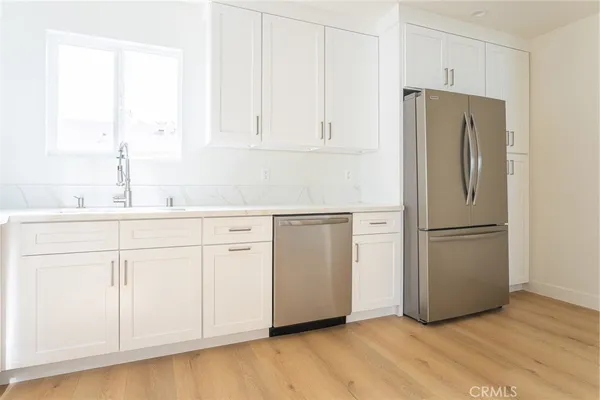 a white refrigerator freezer sitting in a kitchen
