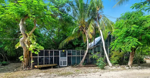 a wooden fence with large trees