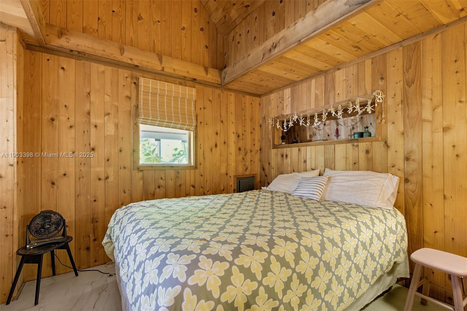 103 Tree Lane Tavernier, FL 33070 - Photo 11 of 33 a bedroom with a bed and a chair