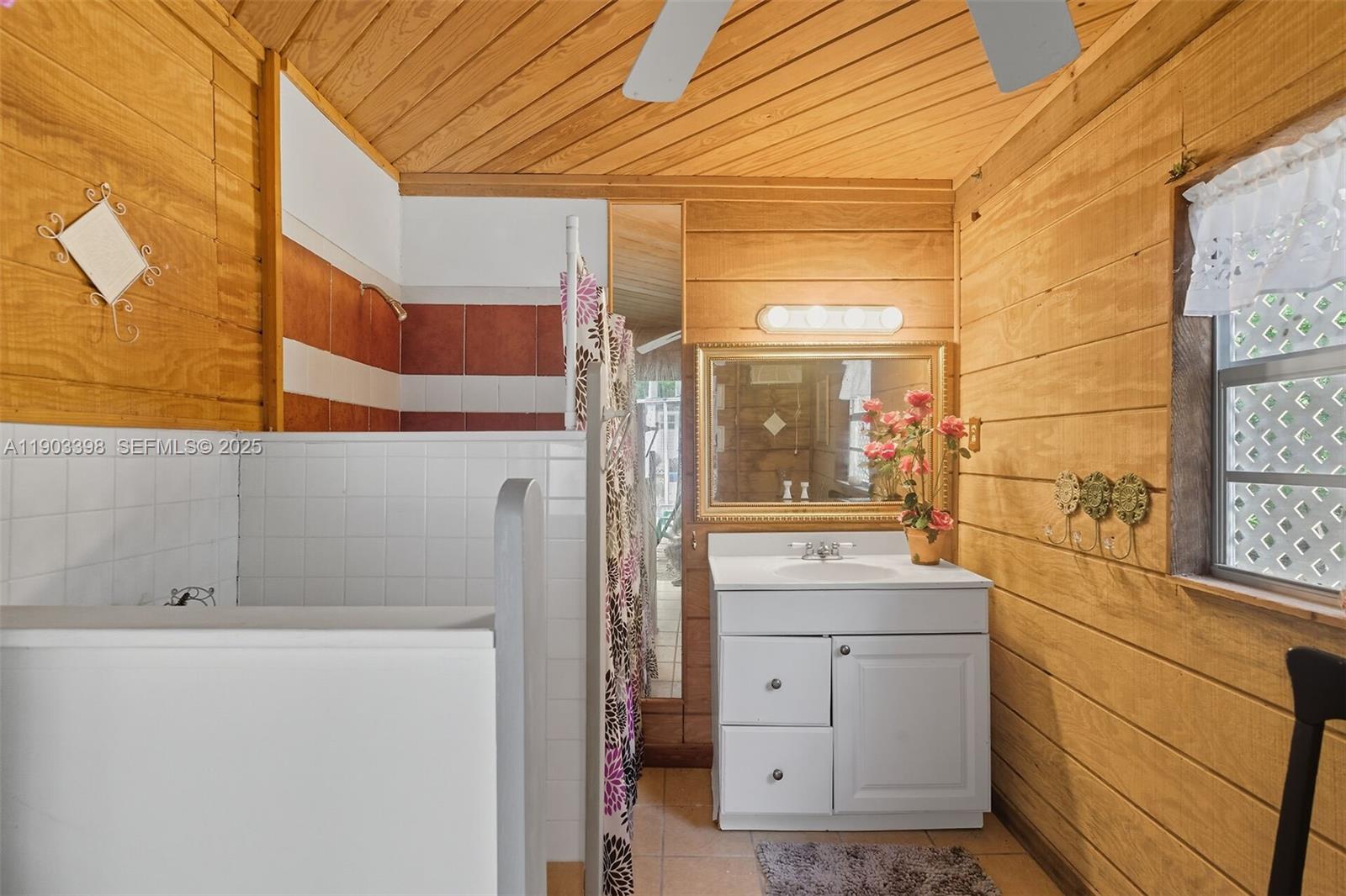 103 Tree Lane Tavernier, FL 33070 - Photo 20 of 33 a bathroom with a sink and a mirror