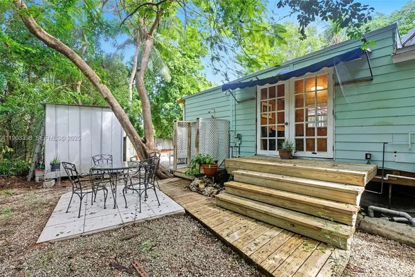 a backyard of a house with outdoor seating