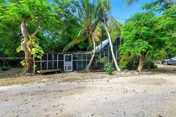 a view of a house with a yard and tree