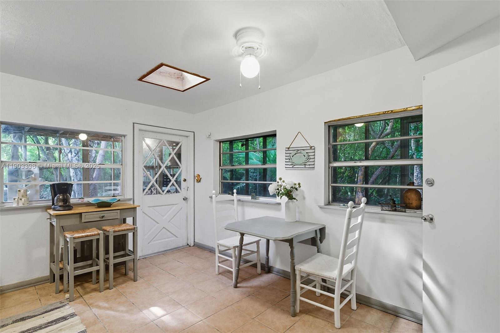103 Tree Lane Tavernier, FL 33070 - Photo 4 of 33 a dining room with furniture and a window