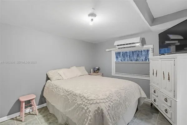 a bedroom with a large bed and a window