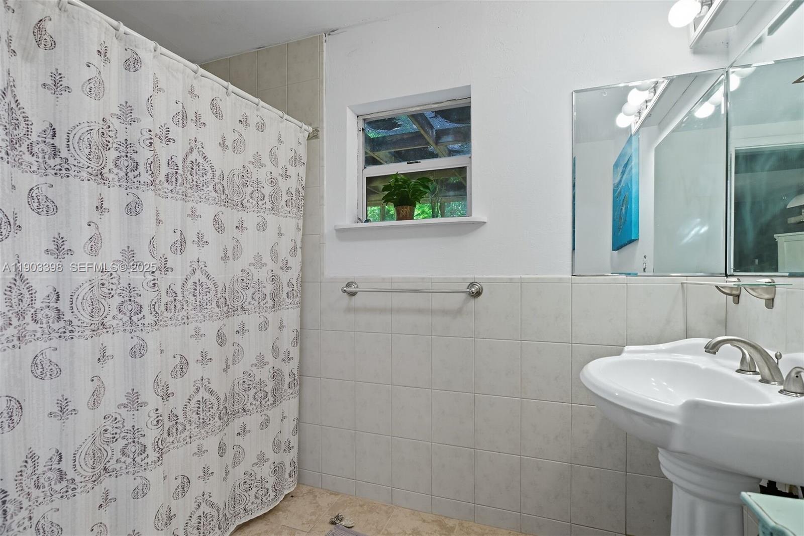 103 Tree Lane Tavernier, FL 33070 - Photo 10 of 33 a bathroom with a sink and a mirror