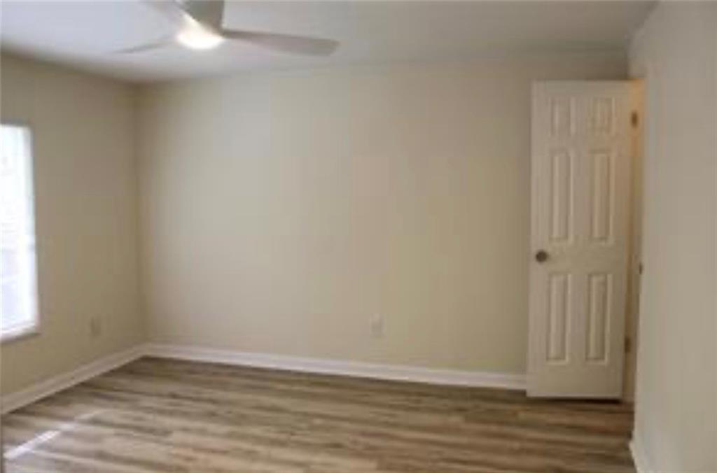 576 Nichols Road Pendergrass, GA 30567 - Photo 19 of 38 a view of an empty room with wooden floor and a window