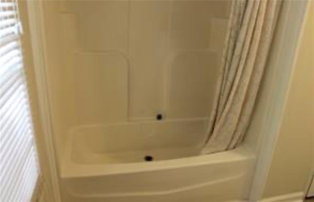 576 Nichols Road Pendergrass, GA 30567 - Photo 25 of 38 a bathroom with a bathtub