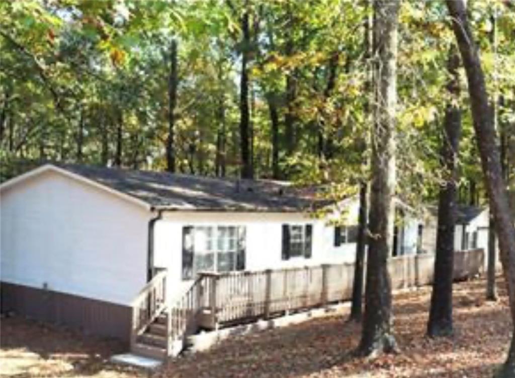 576 Nichols Road Pendergrass, GA 30567 - Photo 3 of 38 a view of a house with a tree in the background