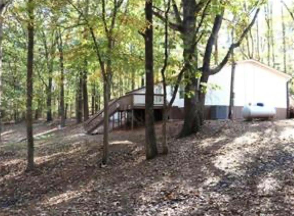 576 Nichols Road Pendergrass, GA 30567 - Photo 38 of 38 a backyard of a house with lots of green space