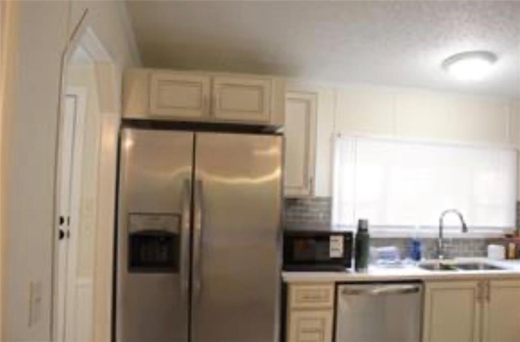 576 Nichols Road Pendergrass, GA 30567 - Photo 8 of 38 a kitchen with stainless steel appliances granite countertop a refrigerator and a sink