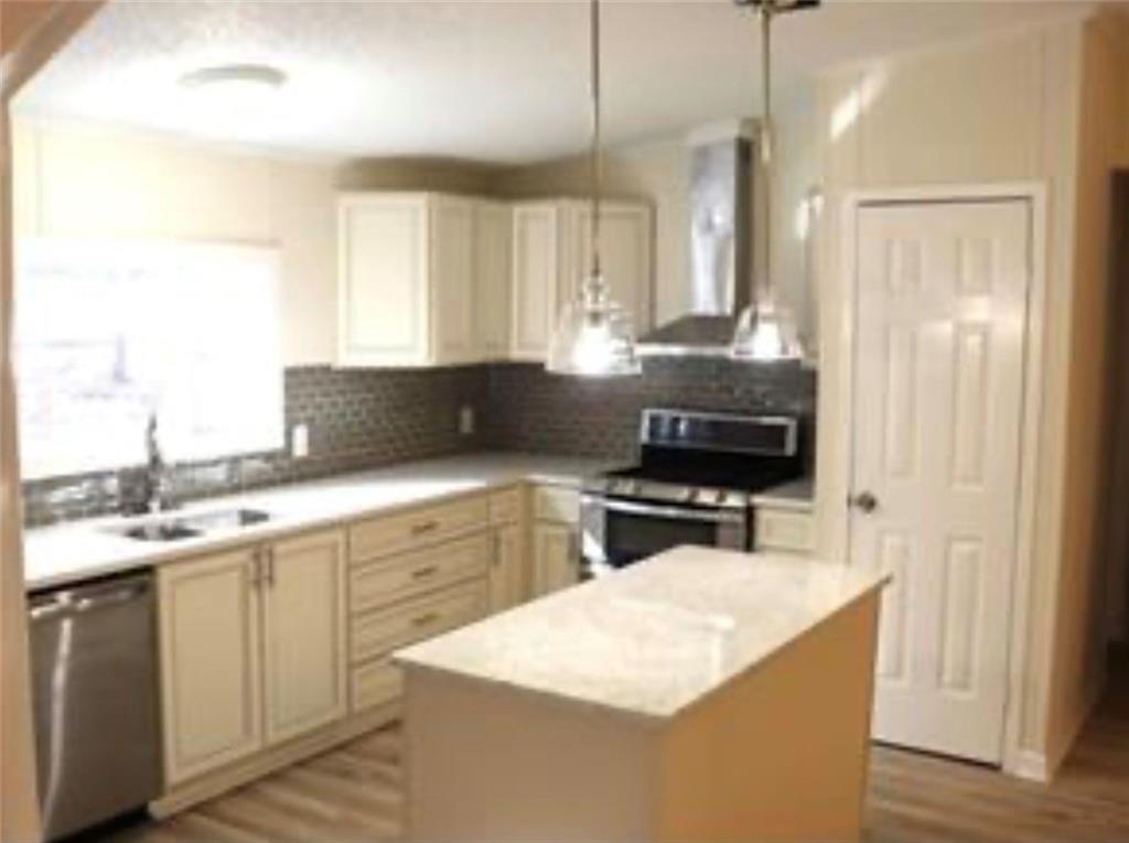 576 Nichols Road Pendergrass, GA 30567 - Photo 10 of 38 a kitchen with a sink stove and refrigerator