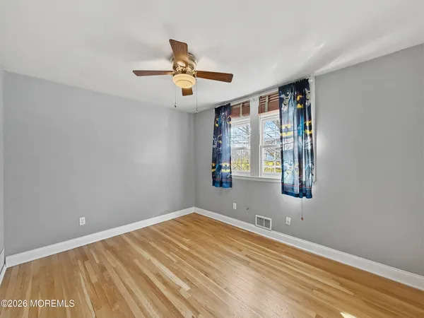 a view of room with a ceiling fan