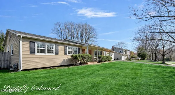 a front view of a house with a garden