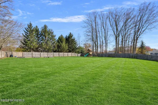 a view of a field with trees in the background