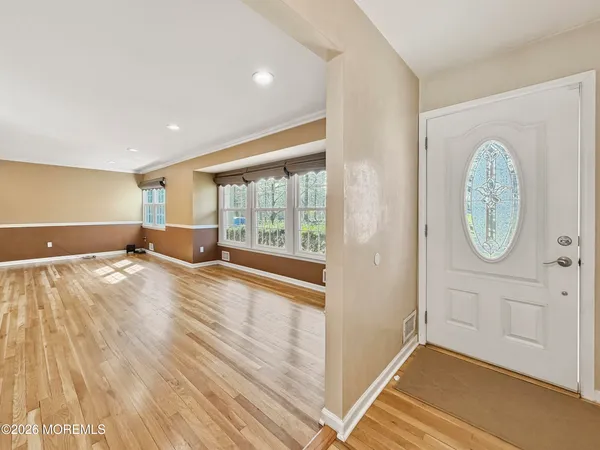 a view of a room with wooden floor and window
