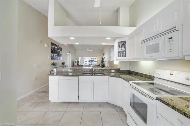 a kitchen with stainless steel appliances granite countertop a sink and cabinets