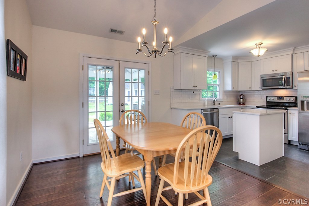 2533 London Road Henrico, VA 23233 - Photo 11 of 35 a view of a dining room with furniture a chandelier and wooden floor
