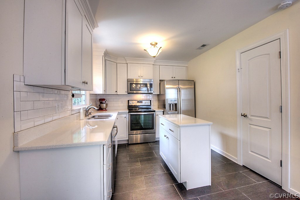 2533 London Road Henrico, VA 23233 - Photo 18 of 35 a kitchen with a sink a counter top space stainless steel appliances and cabinets