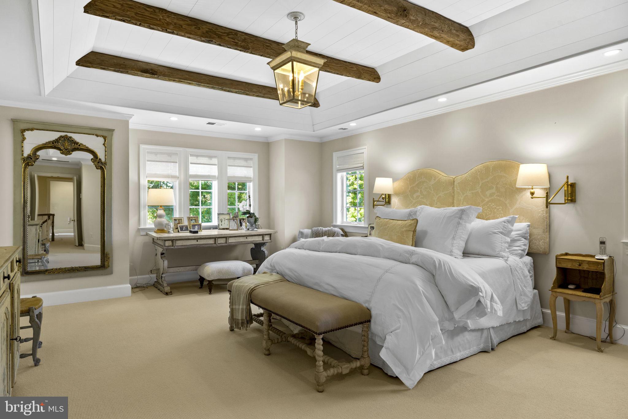 36190 Turkey Roost Road Middleburg, VA 20117 - Photo 37 of 88 a spacious bedroom with a bed couch chandelier and a window