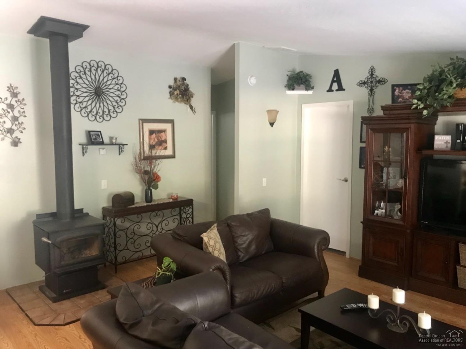 Living Room with Wood Stove that keeps t