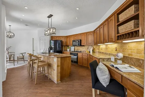 a kitchen with a table chairs stove and microwave