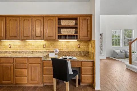 a kitchen with a sink cabinets and wooden floor
